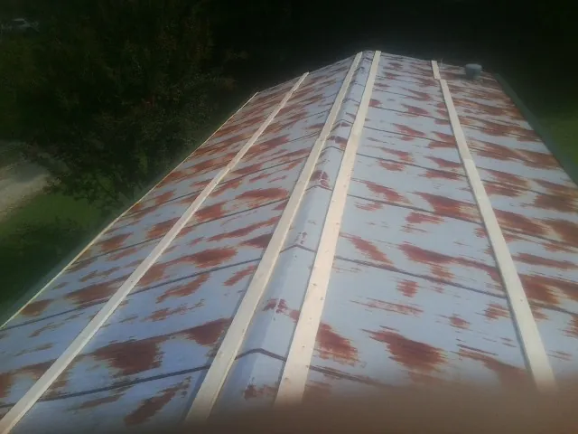 Rusted metal roof panels with new wood purlins before replacement — Storm Damage Roof Repair in Lawnside by Roofing Brothers