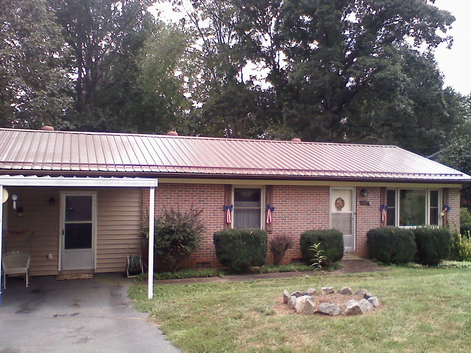 Bronze metal roof and carport on a brick ranch home — Roof Repair work by our crew in Lawnside