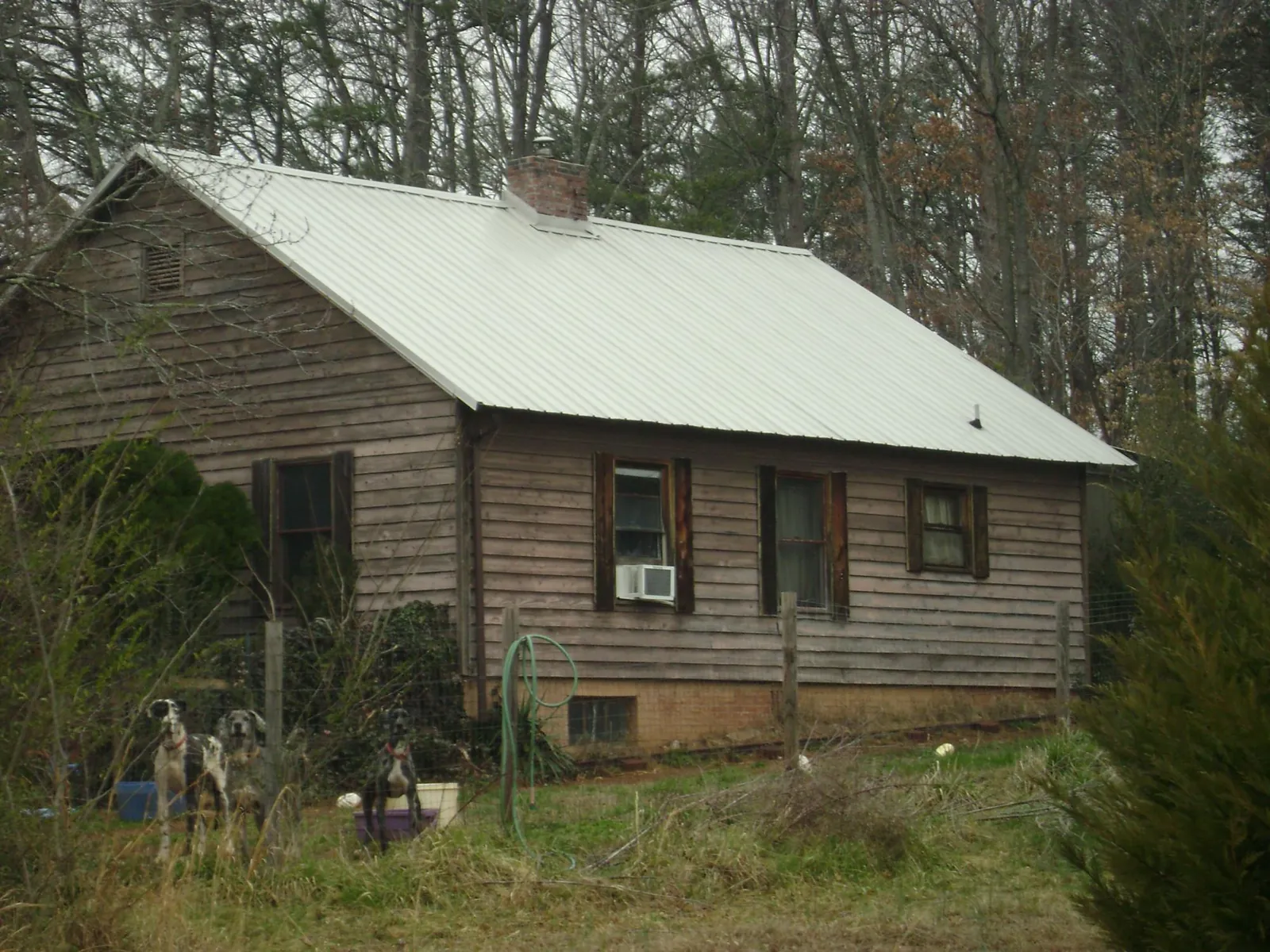 White metal roof on an old wood sided farmhouse, from a Metal Roof Installation job in Lawnside